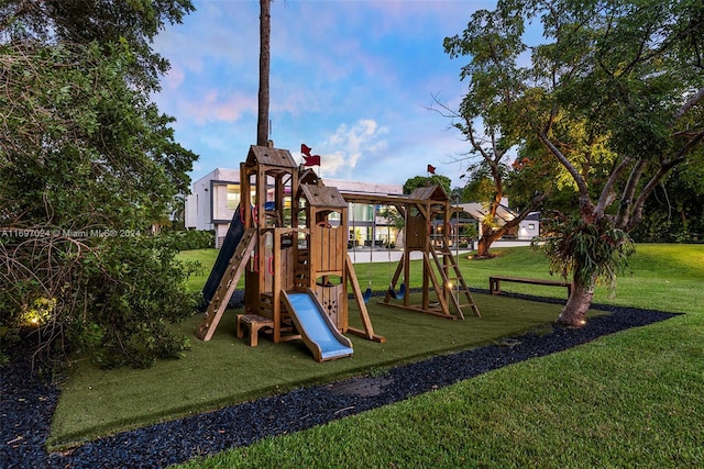 view of playground with a lawn