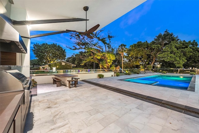 view of swimming pool featuring a grill and a patio