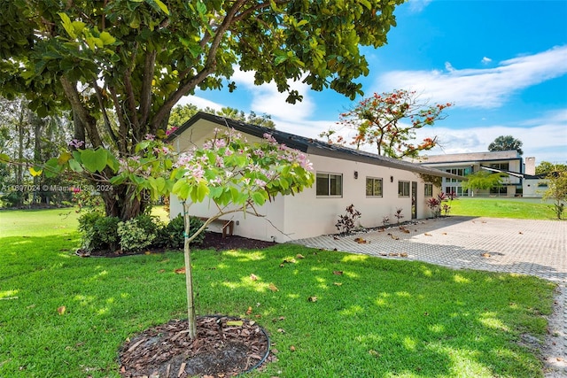 view of home's exterior featuring a yard and a patio area