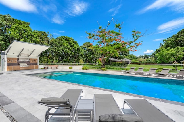 view of swimming pool with a patio area