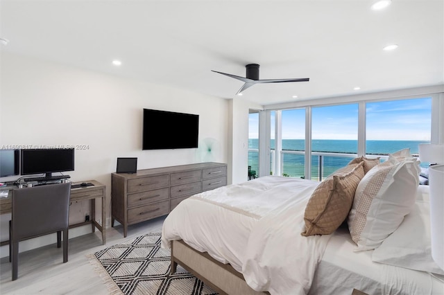 bedroom featuring ceiling fan, access to exterior, and light hardwood / wood-style flooring