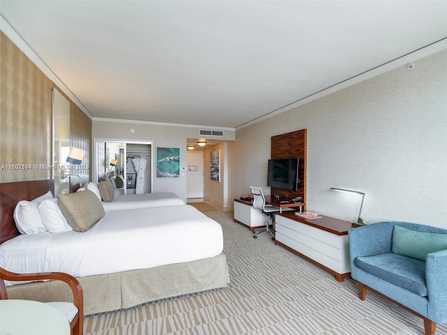 carpeted bedroom with a spacious closet, ornamental molding, and a closet