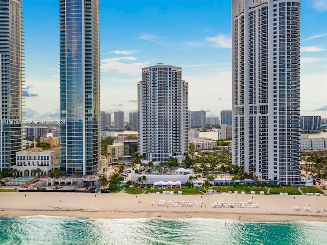 view of city featuring a water view and a beach view