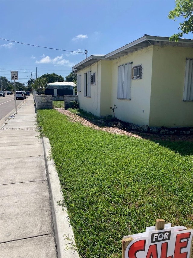 view of property exterior with a yard