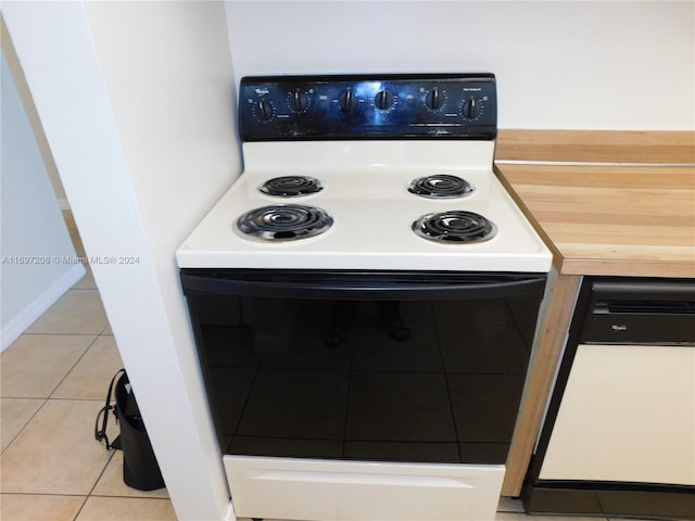 kitchen with dishwashing machine, light tile patterned floors, and electric range