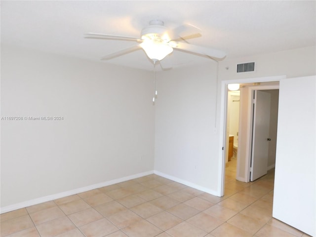 unfurnished room featuring ceiling fan and light tile patterned floors