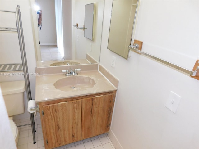 bathroom with tile patterned floors, vanity, and toilet