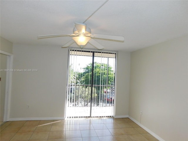 tiled empty room with ceiling fan