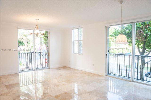 unfurnished room featuring a textured ceiling, an inviting chandelier, plenty of natural light, and ornamental molding