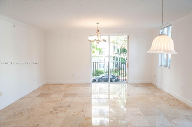 unfurnished room with a chandelier, a textured ceiling, and ornamental molding