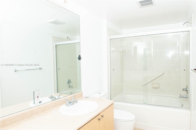 full bathroom featuring vanity, toilet, and enclosed tub / shower combo