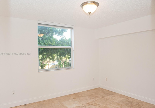 empty room featuring a textured ceiling