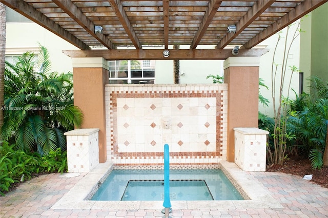 view of swimming pool with an in ground hot tub and a pergola