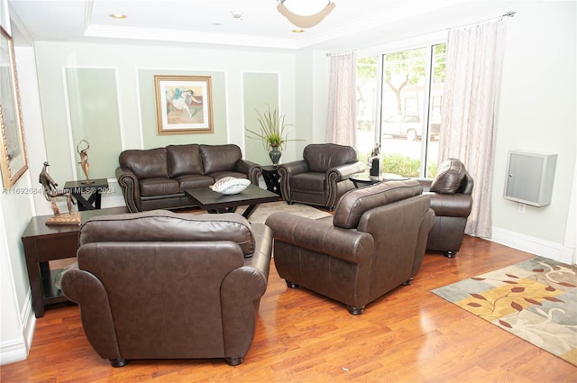 living room featuring wood-type flooring and ornamental molding