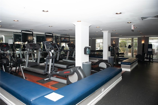 workout area with ornate columns and ornamental molding