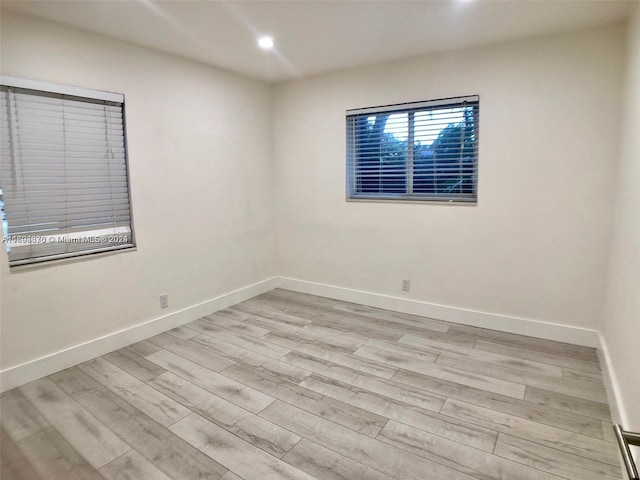 spare room with light hardwood / wood-style flooring