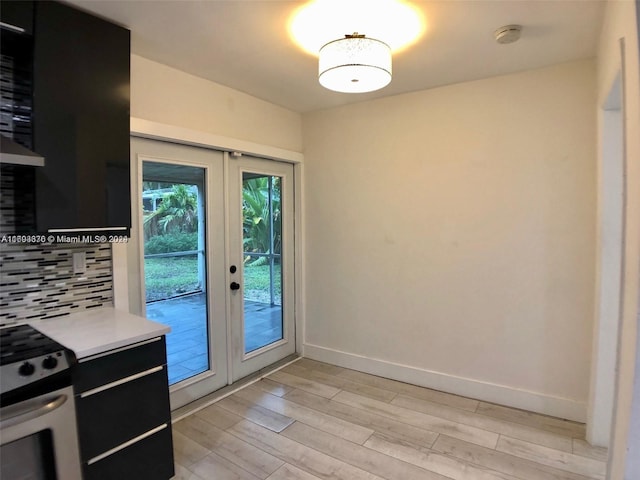 doorway to outside featuring light hardwood / wood-style floors and french doors