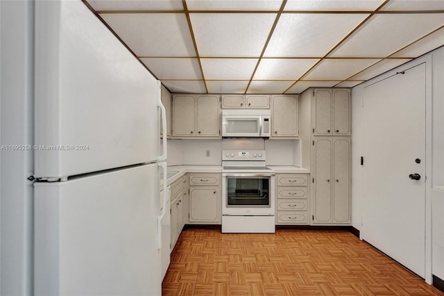 kitchen with white appliances and light parquet floors