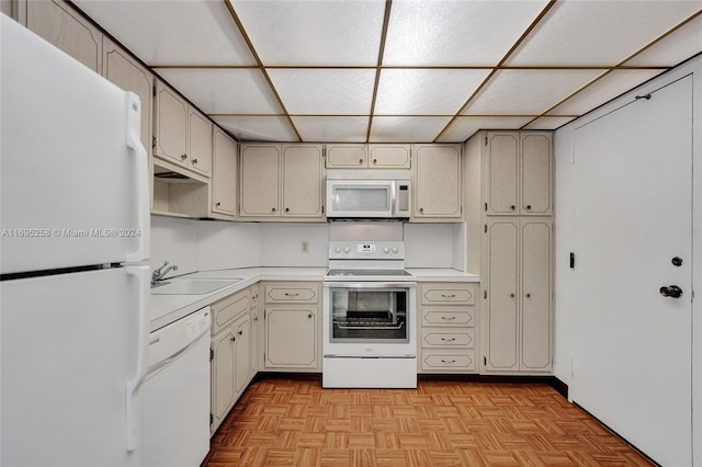 kitchen featuring white appliances, light parquet flooring, and sink