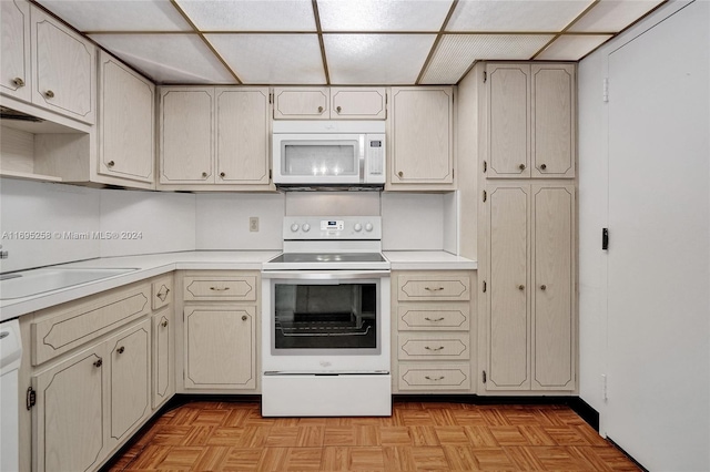 kitchen featuring white appliances, sink, and light parquet floors