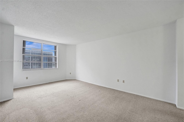 empty room featuring carpet floors and a textured ceiling