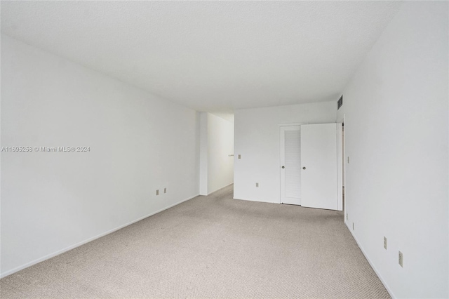 unfurnished bedroom with light carpet