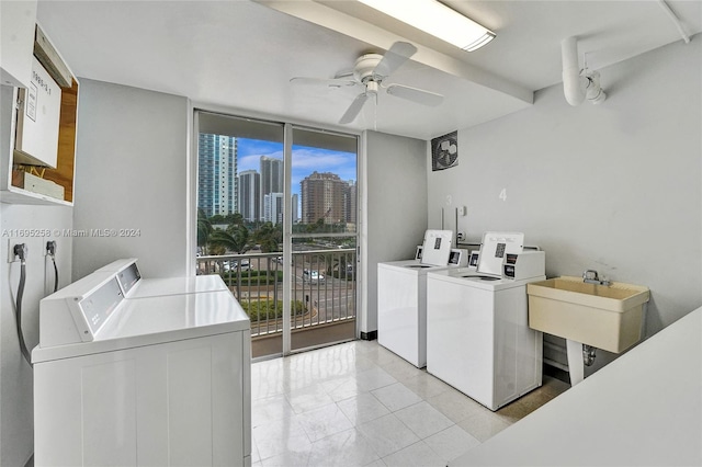 laundry room with ceiling fan, independent washer and dryer, and sink