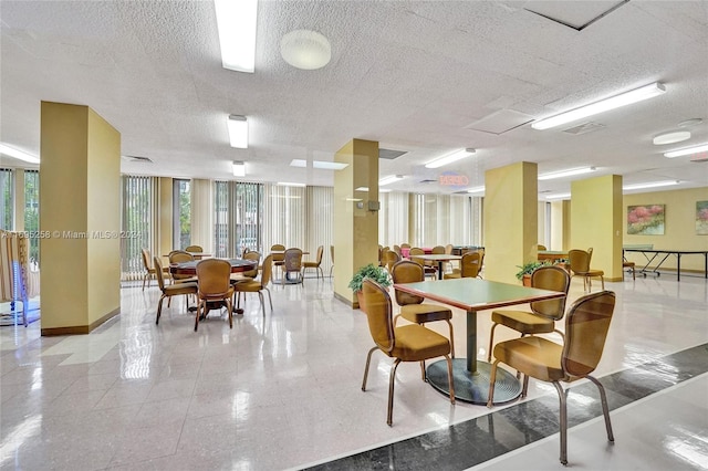 dining space with a textured ceiling