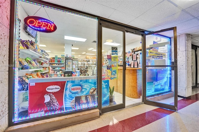 interior space with a paneled ceiling