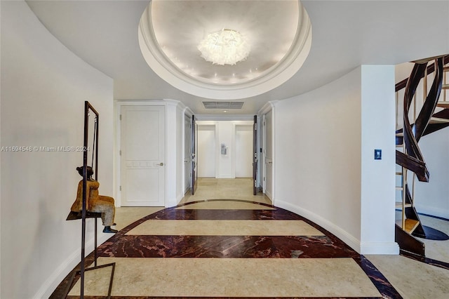 hallway with a tray ceiling