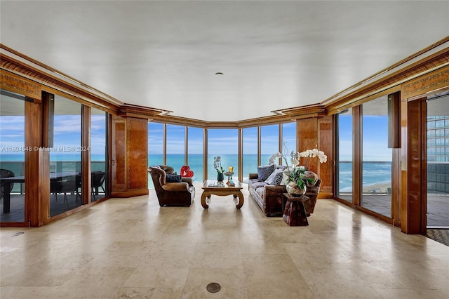 sunroom / solarium featuring a water view