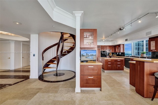 kitchen featuring dishwasher, a center island, rail lighting, decorative backsplash, and ornamental molding