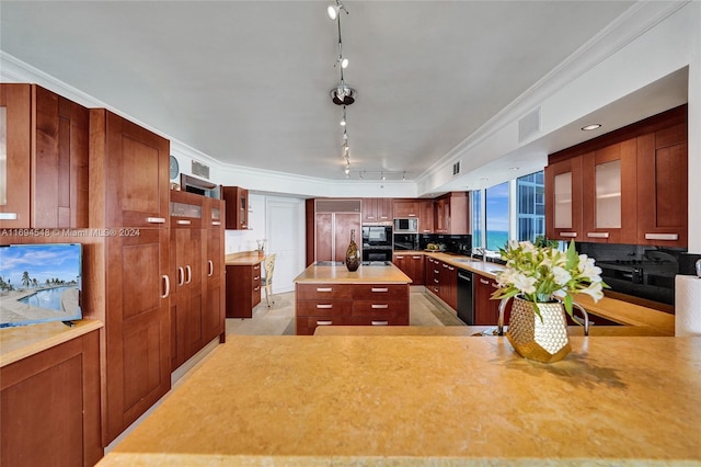 kitchen featuring rail lighting, a kitchen island, crown molding, and sink