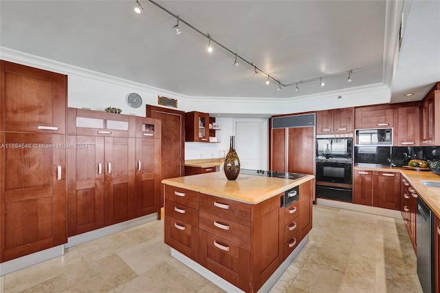 kitchen featuring decorative backsplash, crown molding, a kitchen island, and black appliances