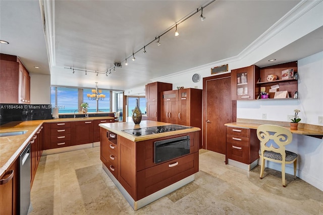 kitchen featuring a center island, black electric cooktop, crown molding, and a chandelier