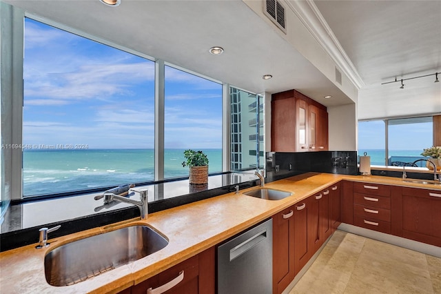 kitchen featuring decorative backsplash, a water view, stainless steel dishwasher, and crown molding