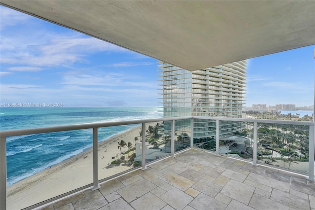 balcony with a water view and a beach view