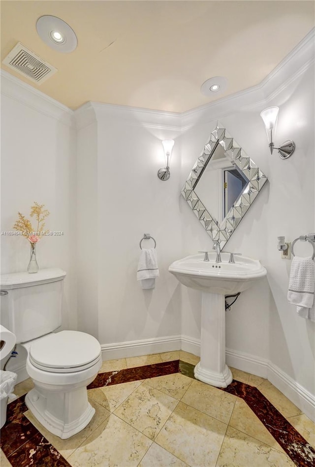 bathroom with toilet and ornamental molding