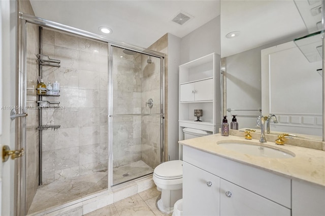 bathroom featuring vanity, an enclosed shower, and toilet