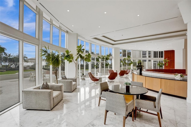 sunroom / solarium featuring a tray ceiling