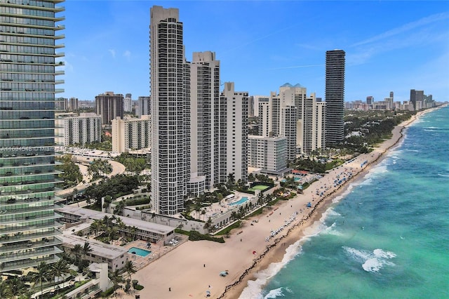 property's view of city with a water view and a beach view