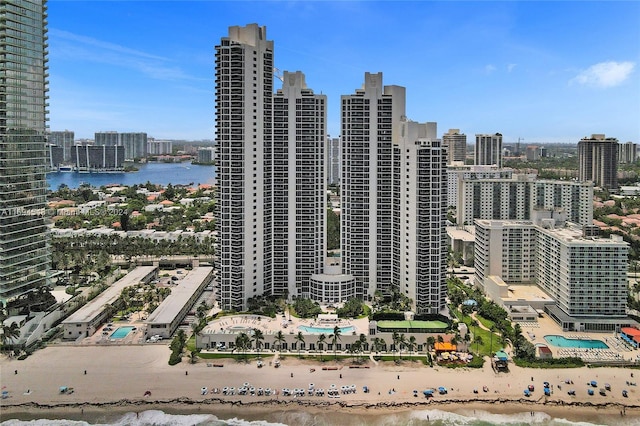 view of city featuring a water view and a beach view