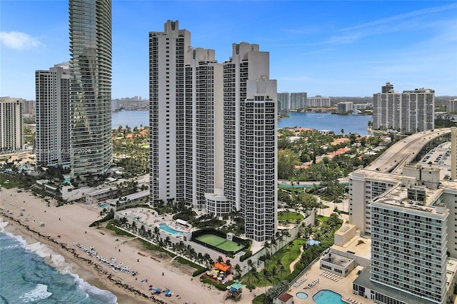 exterior space with a water view and a beach view