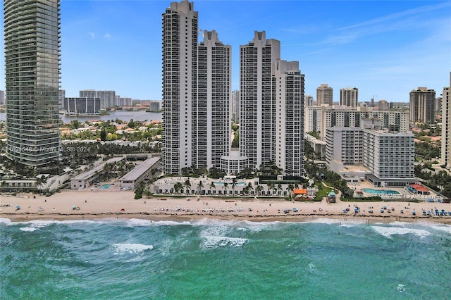 property's view of city with a water view and a beach view