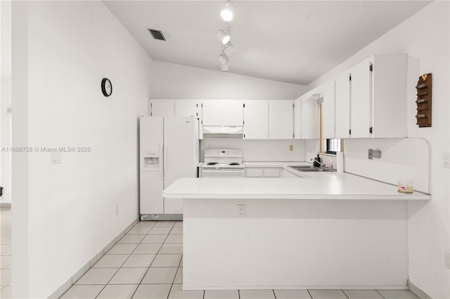 kitchen with kitchen peninsula, vaulted ceiling, white appliances, and white cabinetry