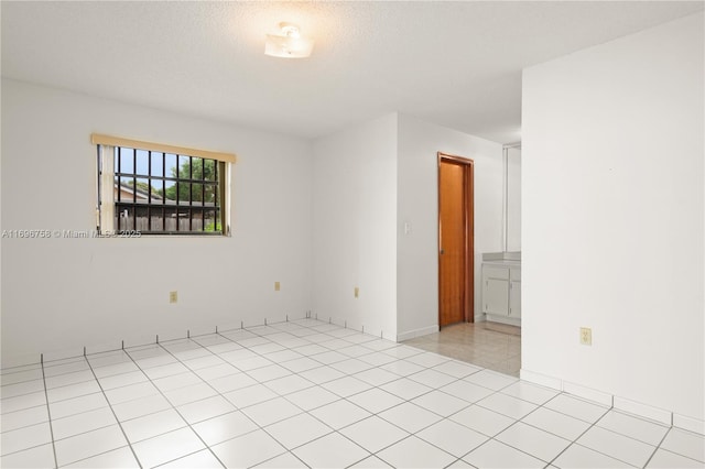 unfurnished room featuring a textured ceiling