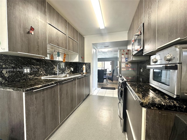 12900 SW 13th St Unit 214E, Pembroke Pines, FL 33027 - kitchen featuring appliances with stainless steel finishes, tasteful backsplash, modern cabinets, and dark brown cabinetry