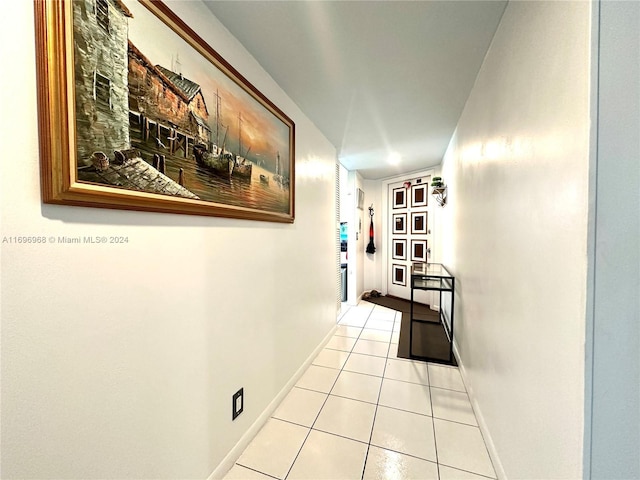 12900 SW 13th St Unit 214E, Pembroke Pines, FL 33027 - hallway featuring light tile patterned flooring and baseboards