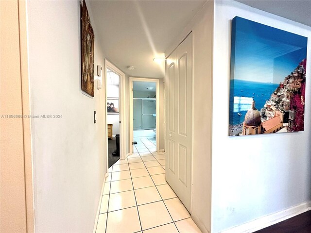 12900 SW 13th St Unit 214E, Pembroke Pines, FL 33027 - hallway featuring light tile patterned flooring