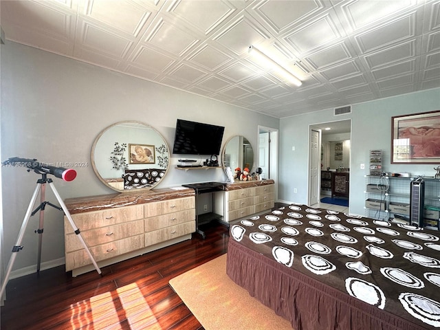 bedroom with dark wood-type flooring